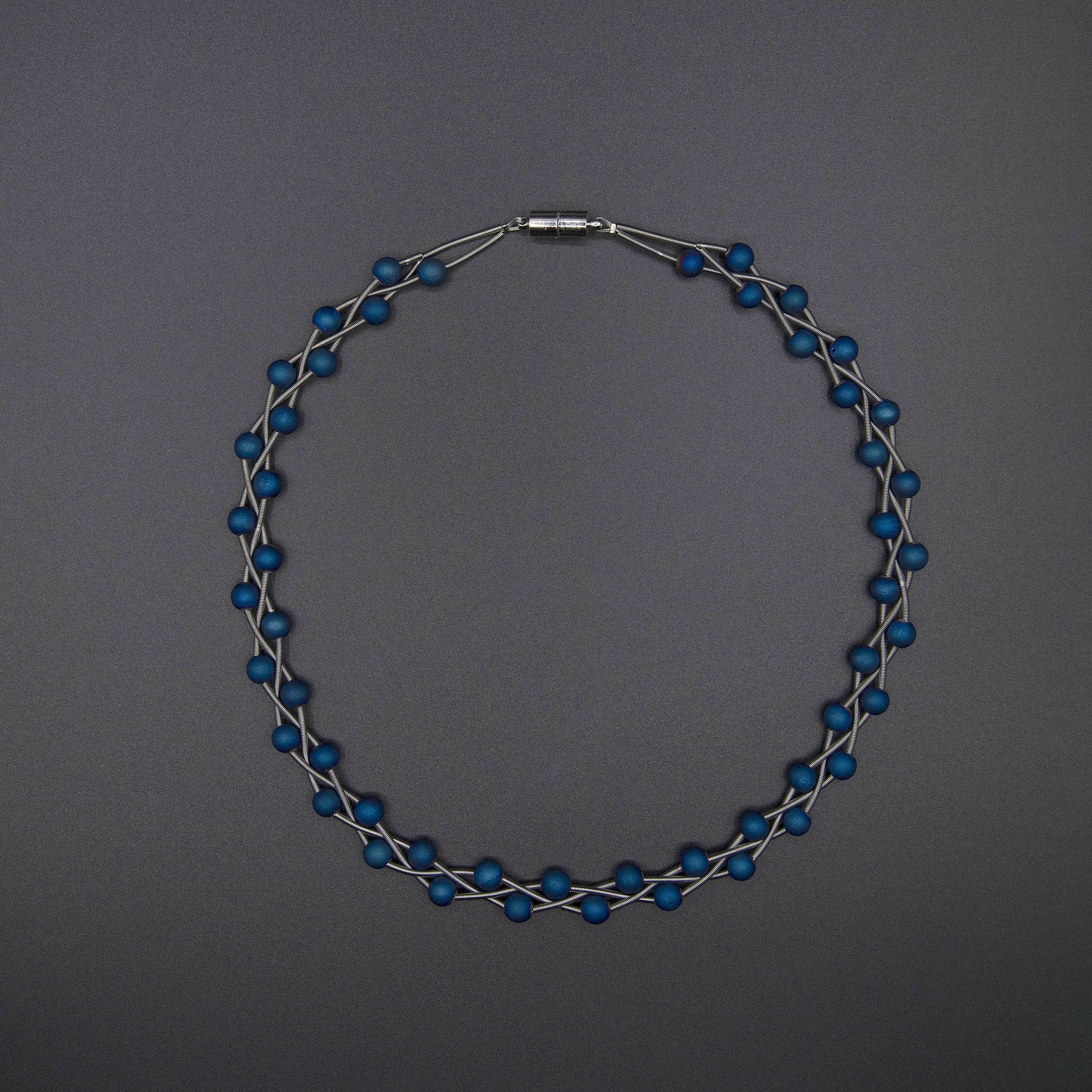 S90B - silver braided piano wire necklace with blue geodes