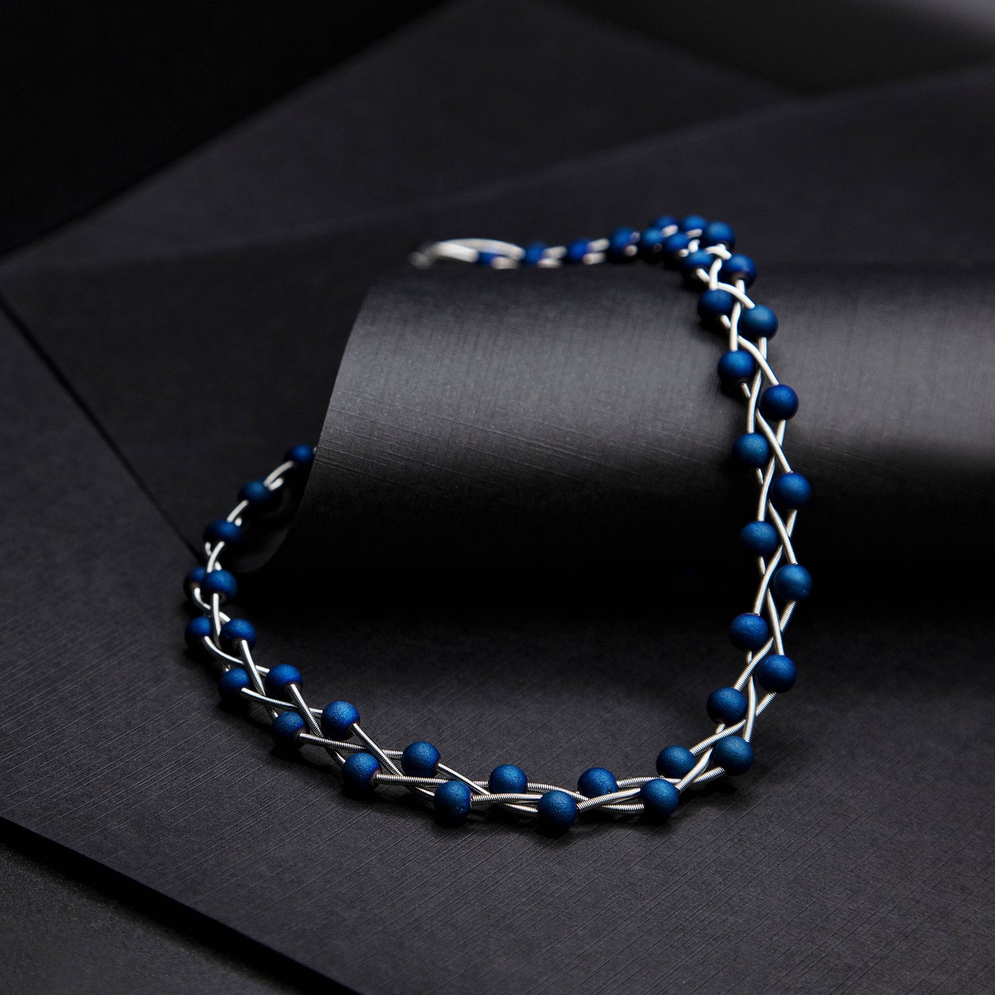 S90B - silver braided piano wire necklace with blue geodes